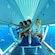 A group of people inside a glass bottom boat watching schools of fish swim in the water